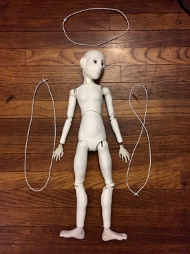 Doll ready to be strung with elastic for the 1st time.